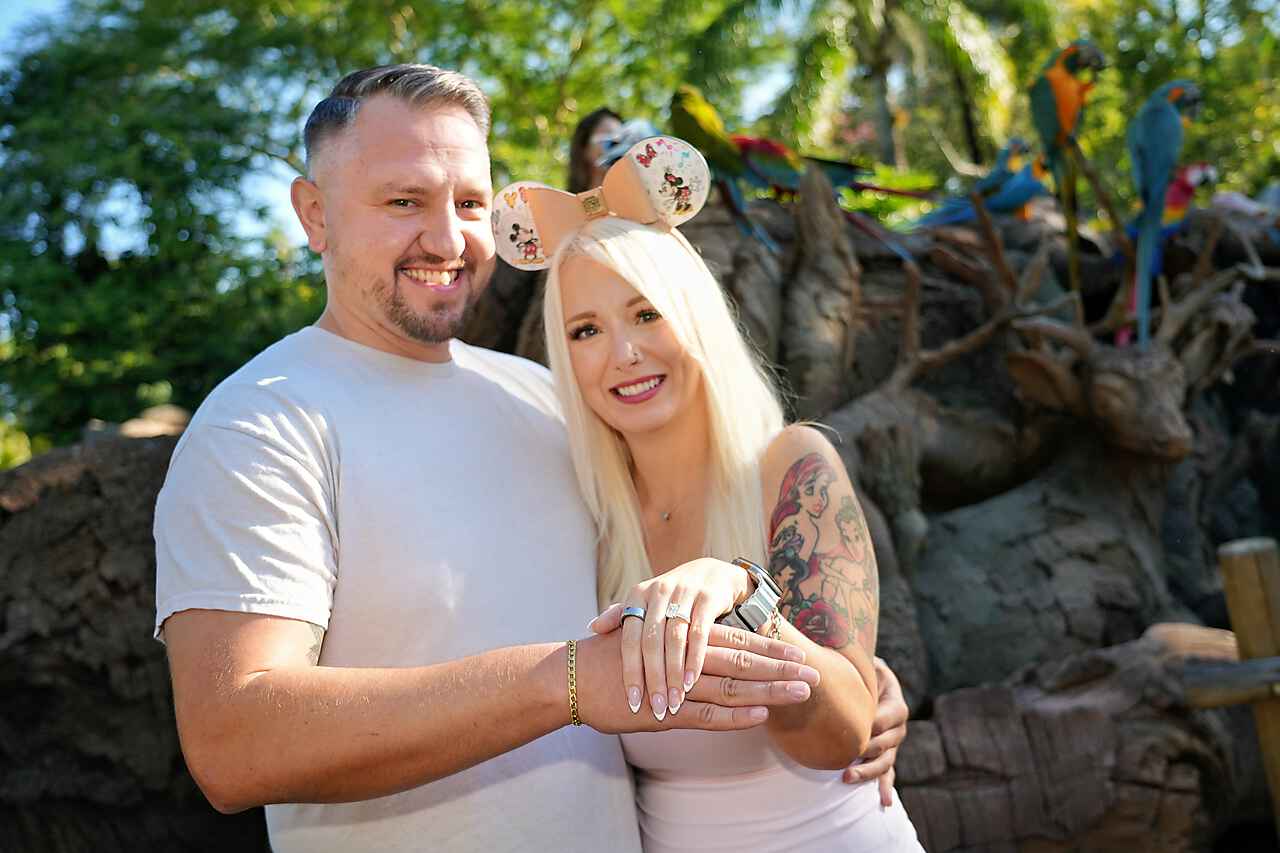 Krystal and Joseph together with the ring in front of the macaws at Animal Kingdom